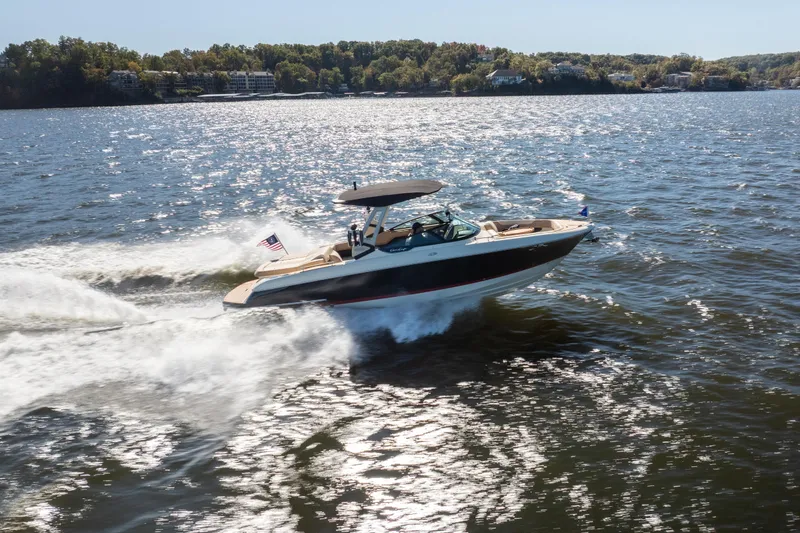 Slide: The Image of 2026 Chris-Craft Sportster 28 speeding on a sunny lake, creating a dynamic water trail. - 33