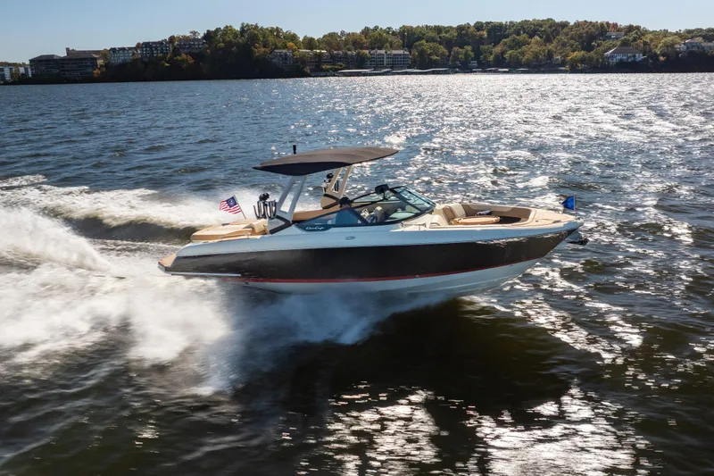 Slide: The Image of 2026 Chris-Craft Sportster 28 cruising on a sunny lake, showcasing sleek design and performance. - 34