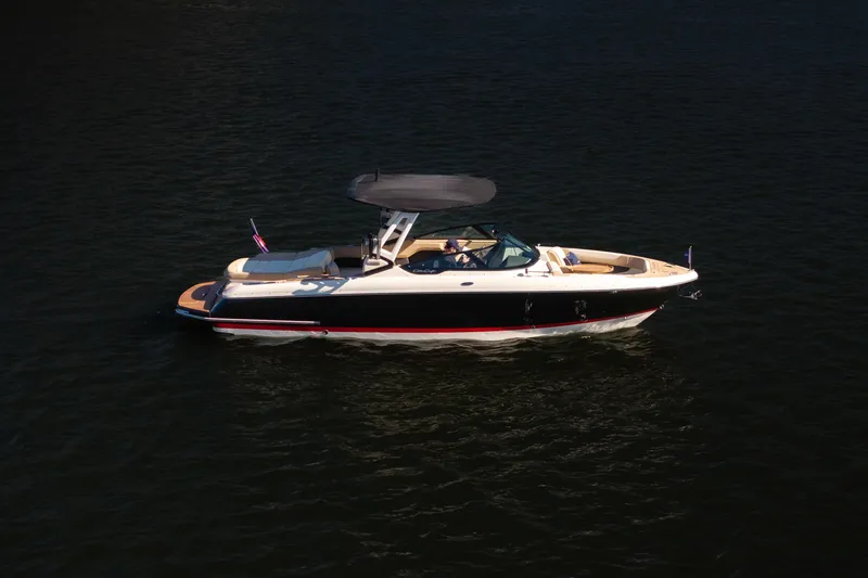 Slide: The Image of 2026 Chris-Craft Sportster 28 boat cruising on calm water. - 36