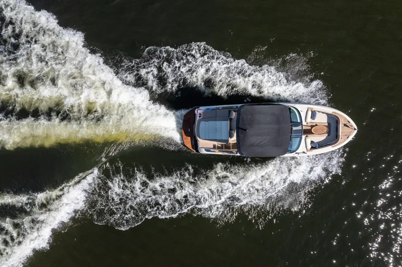 Slide: The Image of Aerial view of 2026 Chris-Craft Sportster 28 boat cruising on water, creating a wake. - 7