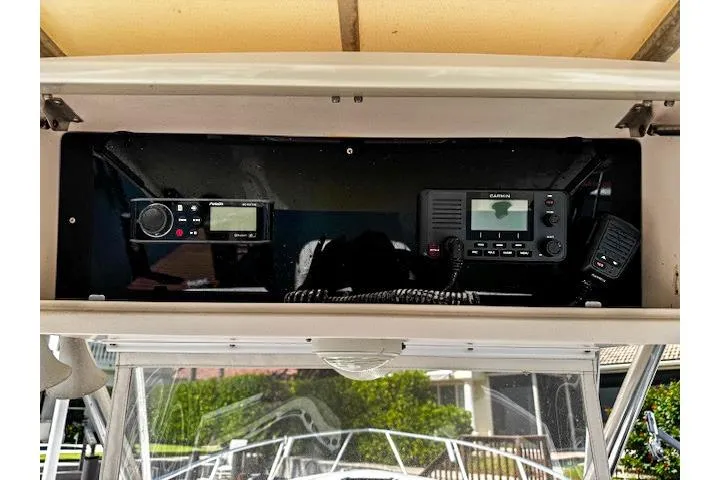 Slide: The Image of 1998 Intrepid 356 Cuddy boat dashboard with navigation and control instruments. - 11