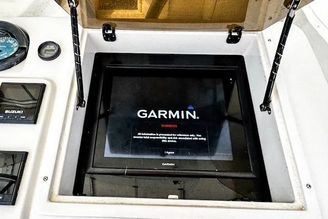 Slide: The Image of 1998 Intrepid 356 Cuddy boat dashboard with Fusion marine stereo and communication equipment. - 13