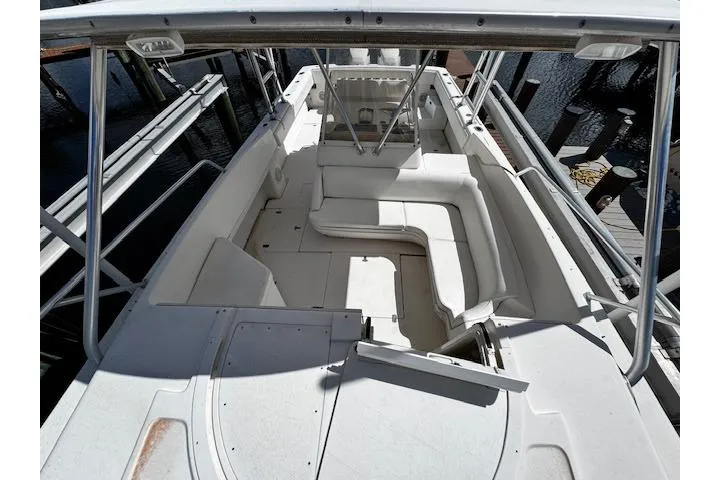Slide: The Image of 1998 Intrepid 356 Cuddy boat deck with railing, docked near wooden pier. - 19