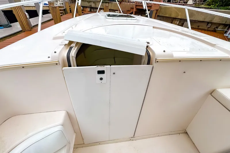 Slide: The Image of 1998 Intrepid 356 Cuddy cabin entrance with open hatch and white deck. - 23