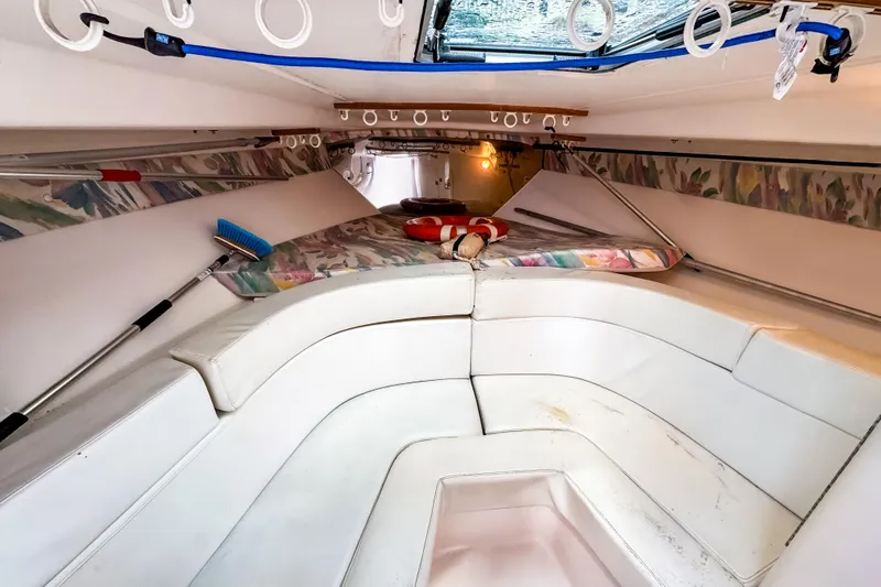 Slide: The Image of Interior of 1998 Intrepid 356 Cuddy boat with white seating and colorful accents. - 29