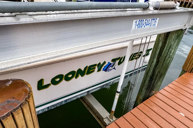 Slide: The Image of Intrepid 356 Cuddy 1998 boat named "Looney Tunes II" docked at marina. - 32