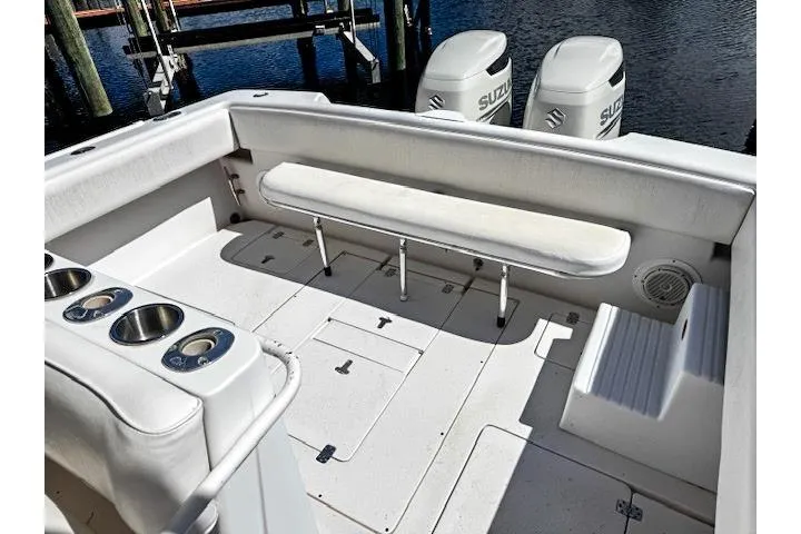 Slide: The Image of 1998 Intrepid 356 Cuddy boat interior with seating, storage, and twin Suzuki outboard engines. - 6