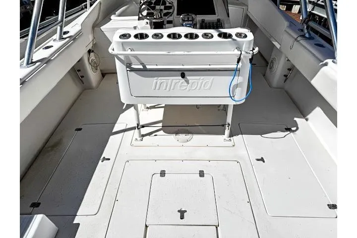 Slide: The Image of 1998 Intrepid 356 Cuddy boat cockpit with steering wheel and control panel. - 7