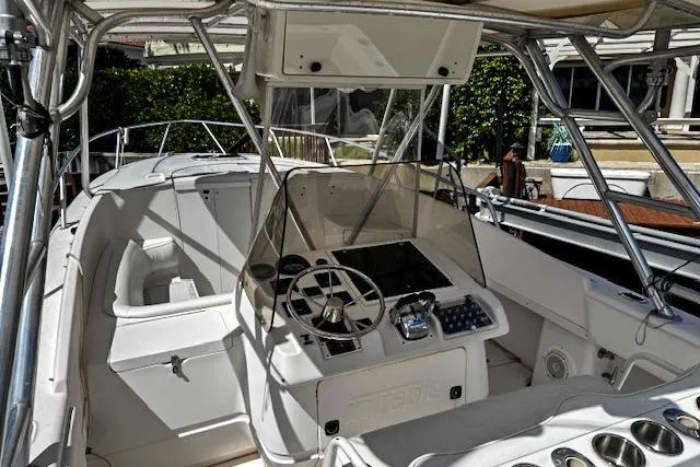 Slide: The Image of 1998 Intrepid 356 Cuddy boat cockpit with steering wheel and control panel. - 9