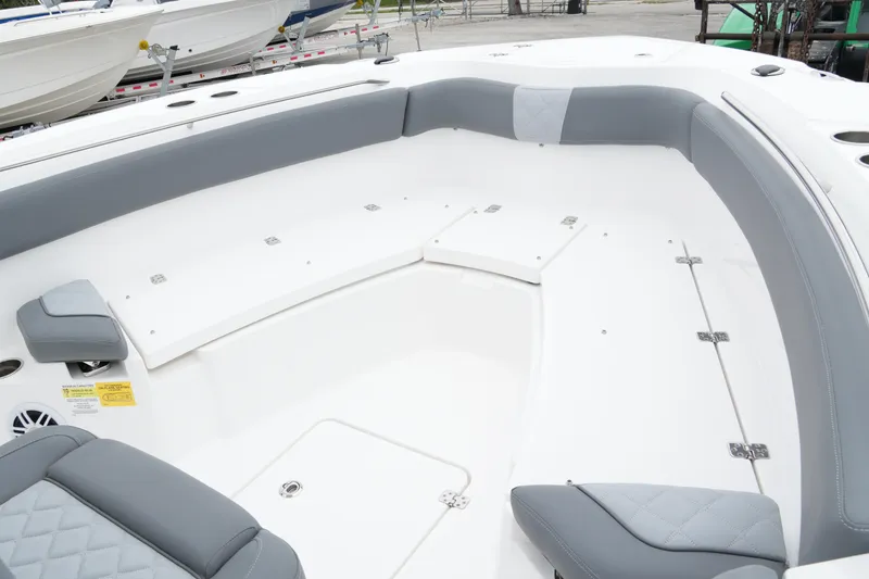 Slide: The Image of 2025 NauticStar 242 Offshore boat interior with gray seating and storage compartments. - 10