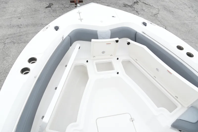 Slide: The Image of 2025 NauticStar 242 Offshore boat interior with spacious seating and storage compartments. - 12