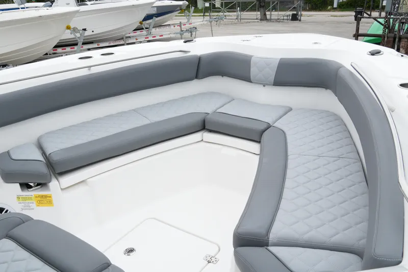 Slide: The Image of 2025 NauticStar 242 Offshore boat with spacious, cushioned seating in gray and white. - 15