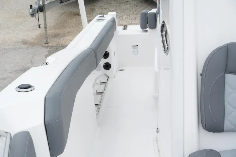 Slide: The Image of 2025 NauticStar 242 Offshore boat interior with gray seating and white deck. - 19