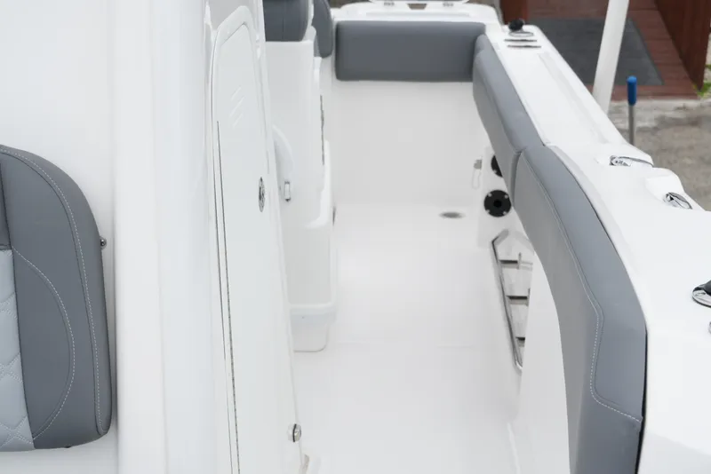 Slide: The Image of 2025 NauticStar 242 Offshore boat interior with sleek gray and white seating. - 20