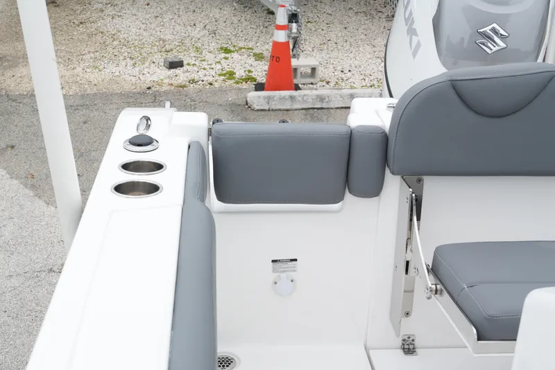 Slide: The Image of 2025 NauticStar 242 Offshore boat interior with gray seating and cup holders. - 22