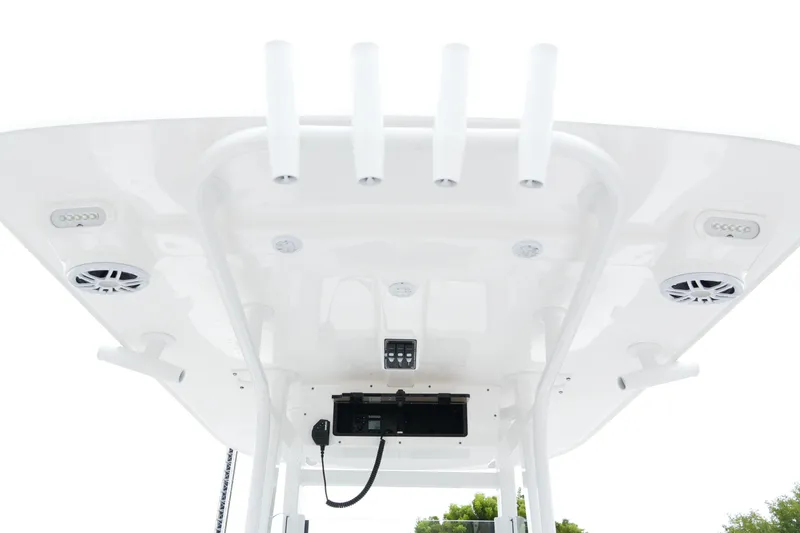 Slide: The Image of 2025 NauticStar 242 Offshore boat roof with rod holders and speakers. - 29