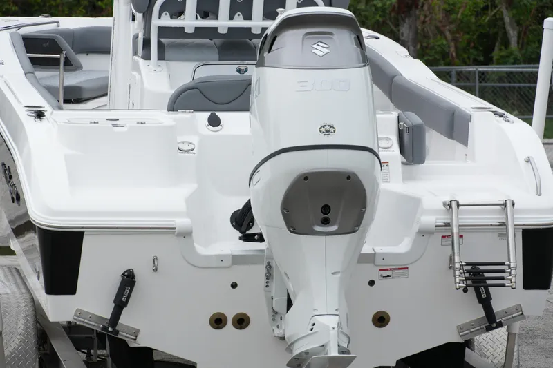 Slide: The Image of 2025 NauticStar 242 Offshore boat with Suzuki 300 outboard motor, rear view. - 3