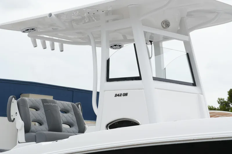 Slide: The Image of 2025 NauticStar 242 Offshore boat with T-top and dual seats, showcasing modern design. - 5