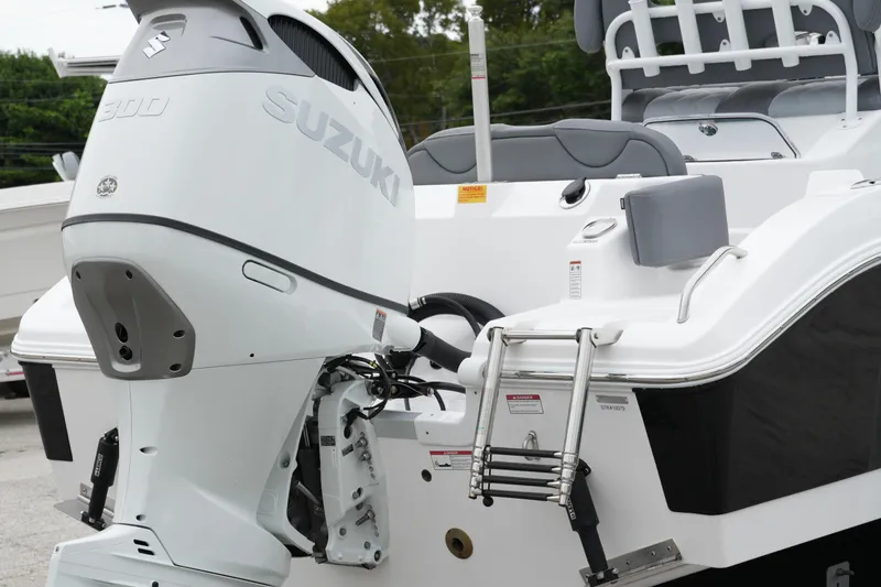 Slide: The Image of 2025 NauticStar 242 Offshore boat with Suzuki 300 outboard motor and swim ladder. - 8