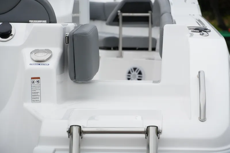 Slide: The Image of 2025 NauticStar 242 Offshore boat interior with seating and fresh water access. - 9