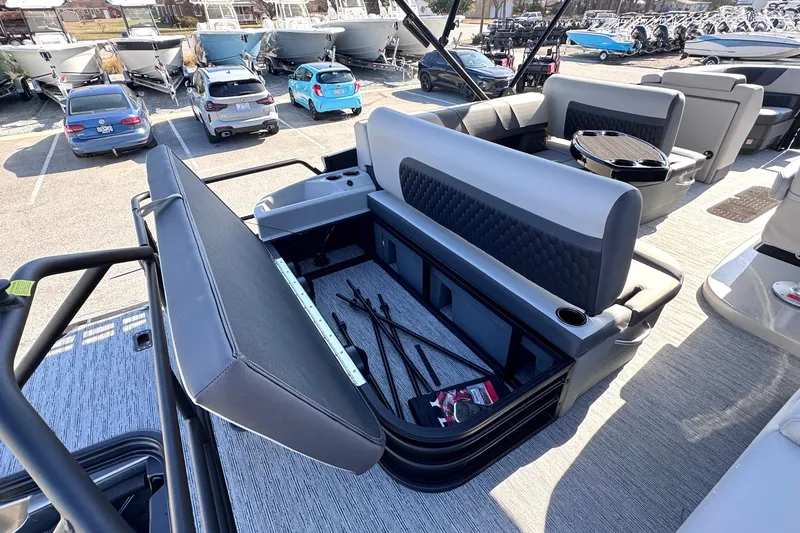Slide: The Image of 2026 Sylvan L3 CLZ pontoon boat interior with storage compartment open, showcasing seating and amenities. - 11