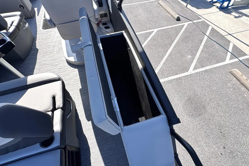 Slide: The Image of 2026 Sylvan L3 CLZ boat interior with open storage compartment and seating. - 12