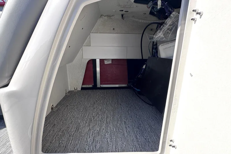 Slide: The Image of Interior storage compartment of 2026 Sylvan L3 CLZ boat, featuring carpeted flooring. - 20