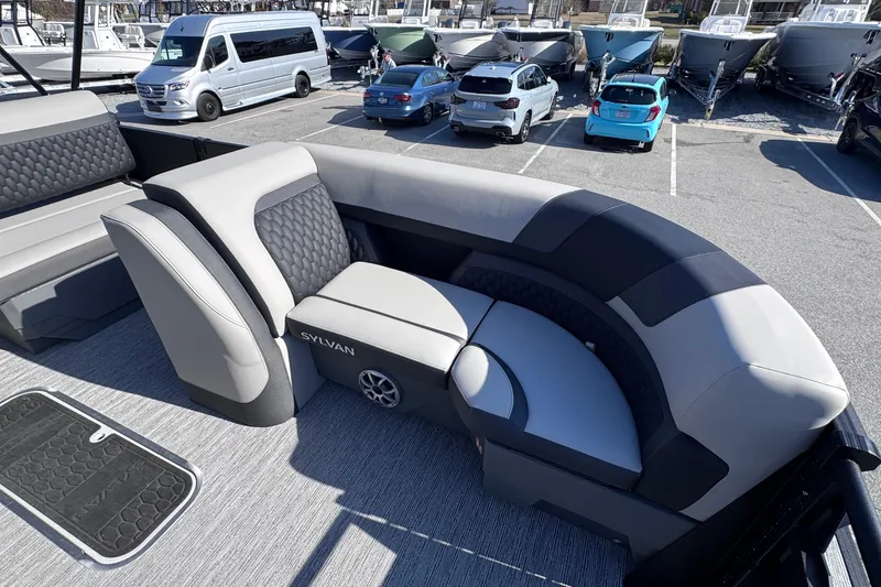 Slide: The Image of Luxurious seating on 2026 Sylvan L3 CLZ pontoon boat in a marina parking lot. - 22