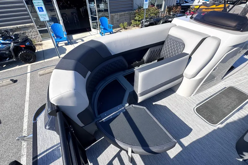 Slide: The Image of 2026 Sylvan L3 CLZ boat interior with gray seating and storage compartment. - 25