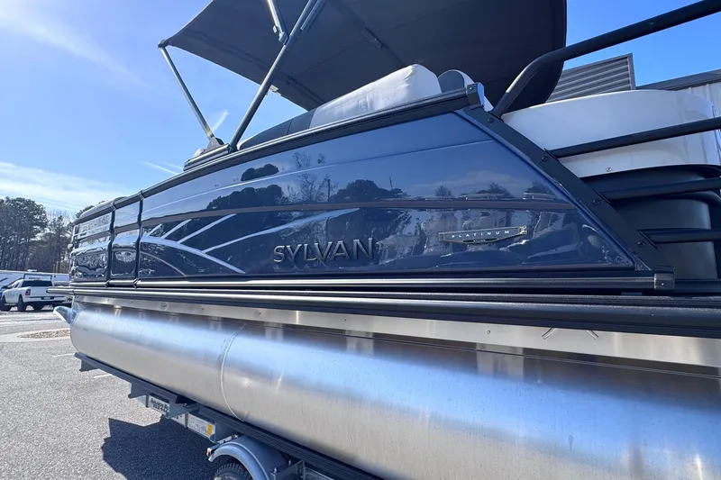 Slide: The Image of 2026 Sylvan L3 CLZ pontoon boat with sleek design and canopy, parked outdoors. - 27
