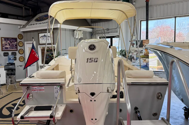 Slide: The Image of 2025 Grady-White Fisherman 180 boat docked by a scenic lakeside. - 2