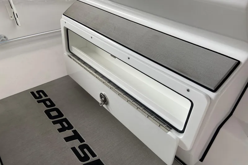 Slide: The Image of 2026 Sportsman Heritage 261 Center Console storage compartment with open lid and cushioned top. - 30