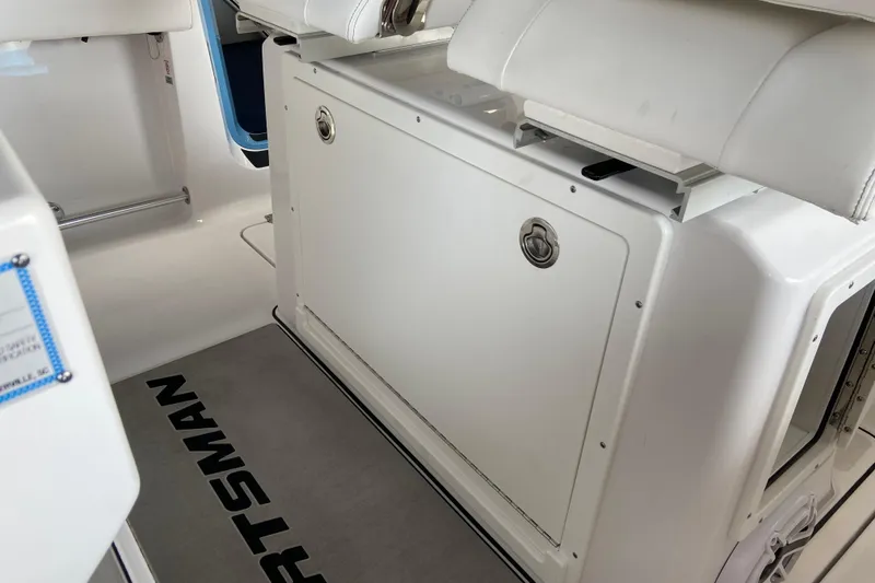 Slide: The Image of 2026 Sportsman Heritage 261 Center Console interior with white seating and storage compartment. - 33