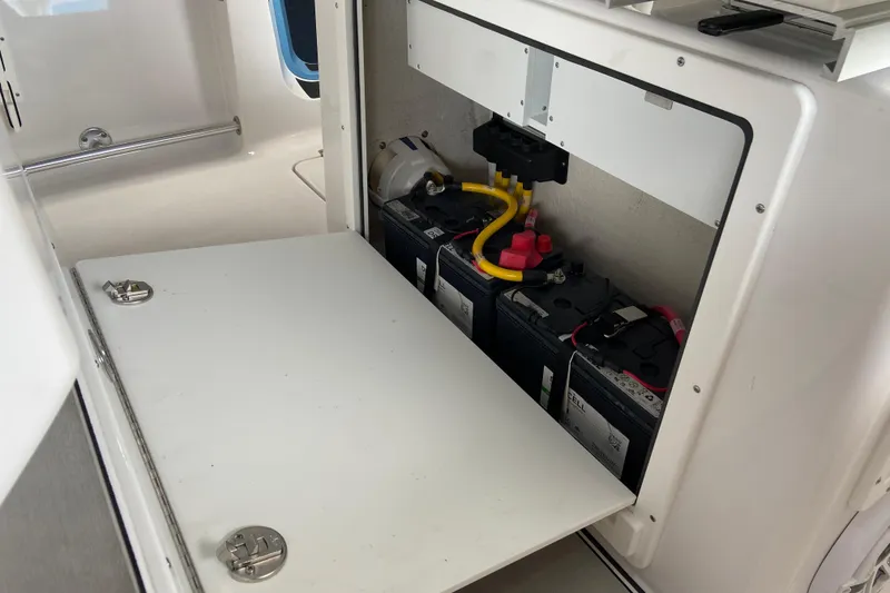 Slide: The Image of Battery compartment of 2026 Sportsman Heritage 261 Center Console boat, showcasing electrical setup. - 34
