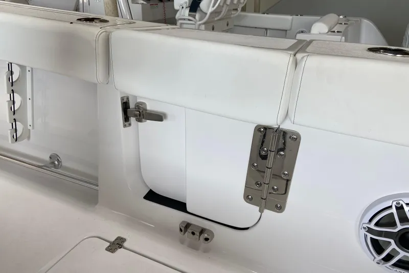 Slide: The Image of 2026 Sportsman Heritage 261 Center Console boat interior with white seating and stainless steel hardware. - 35