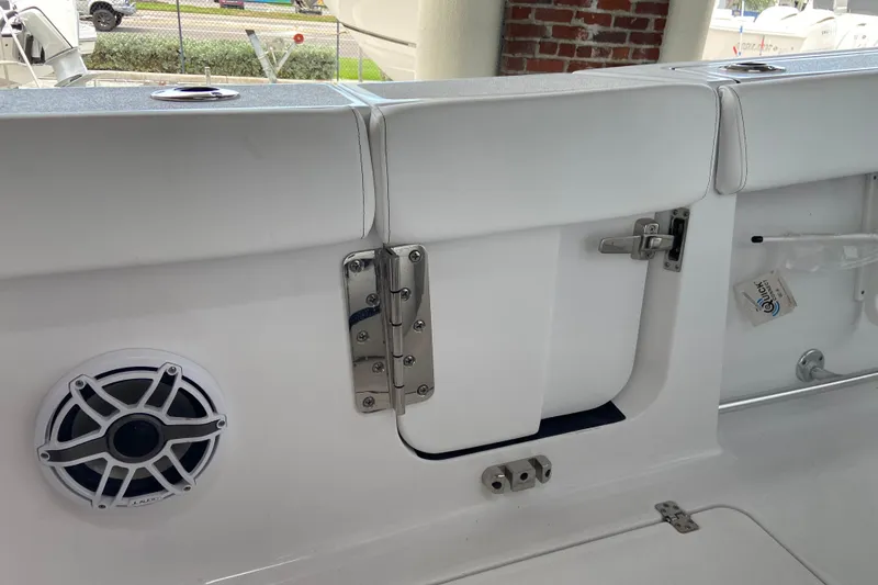 Slide: The Image of Interior view of 2026 Sportsman Heritage 261 Center Console boat, featuring speaker and storage compartment. - 37