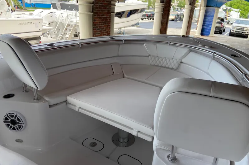Slide: The Image of 2026 Sportsman Heritage 261 Center Console boat interior with cushioned seating and speaker. - 42