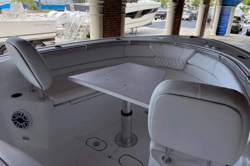 Slide: The Image of 2026 Sportsman Heritage 261 Center Console boat interior with seating and table. - 43