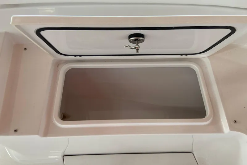 Slide: The Image of Open storage compartment on 2026 Sportsman Heritage 261 Center Console boat. - 47