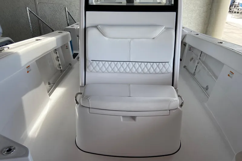 Slide: The Image of 2026 Sportsman Heritage 261 Center Console boat interior with white seating and sleek design. - 52