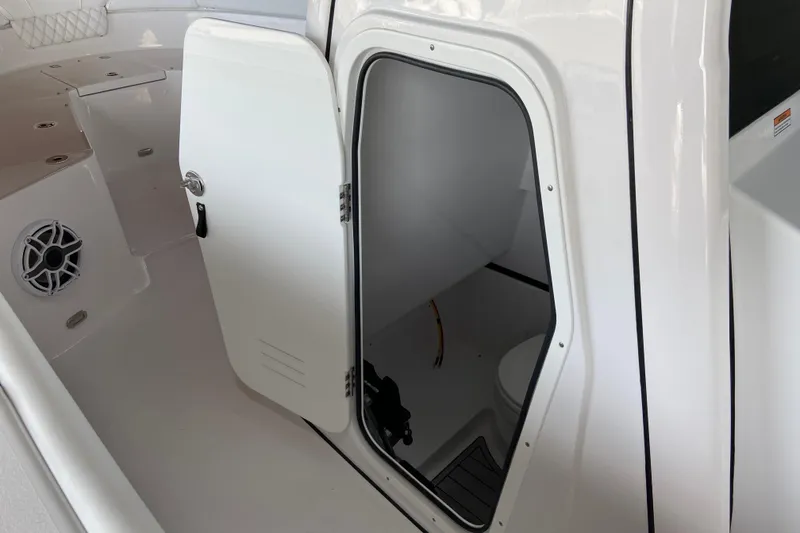 Slide: The Image of 2026 Sportsman Heritage 261 Center Console boat interior with open storage compartment. - 55