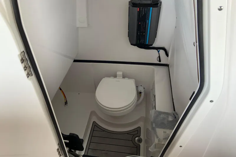 Slide: The Image of Interior of 2026 Sportsman Heritage 261 Center Console boat's compact bathroom. - 56