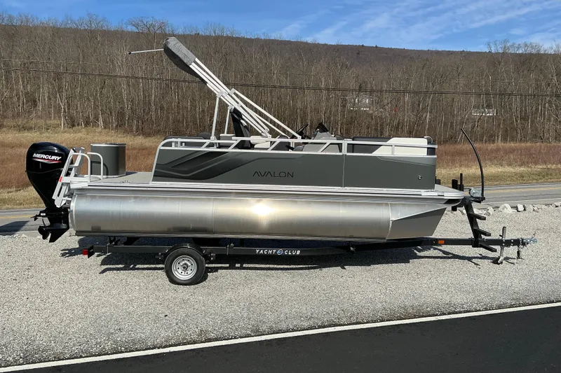 The Image of 2026 Avalon Venture 19 CRB pontoon boat on trailer, parked outdoors. - 0