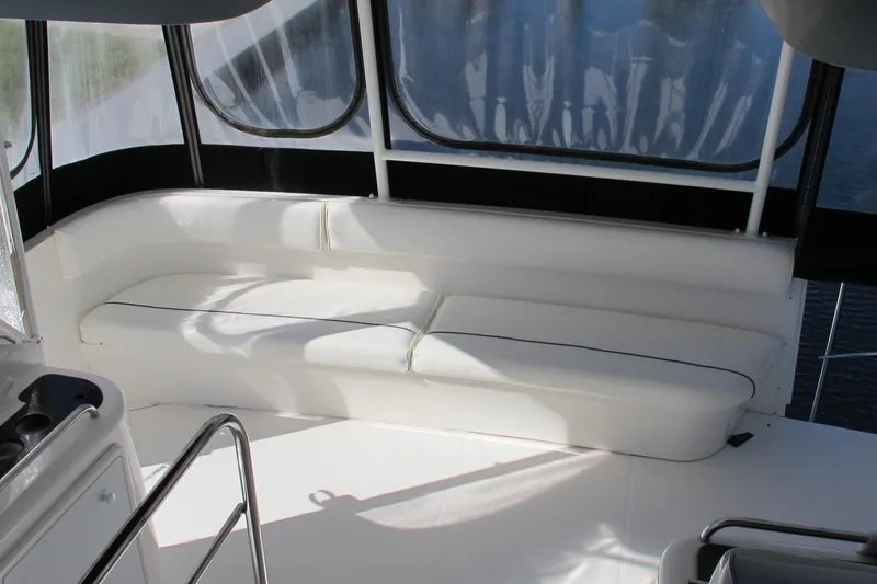 Slide: The Image of 2006 Cruisers Yachts 385 Motoryacht interior with white seating and panoramic windows. - 20