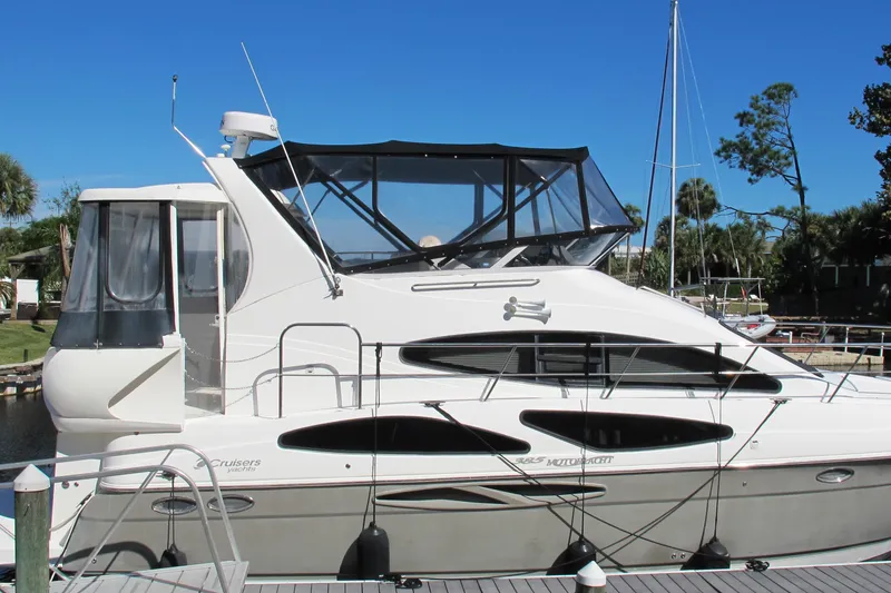 Slide: The Image of 2006 Cruisers Yachts 385 Motoryacht docked, featuring sleek design and spacious upper deck. - 3