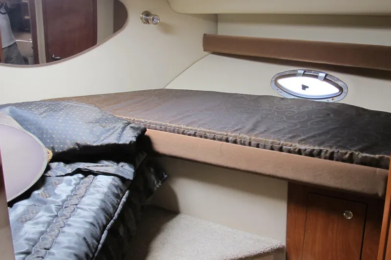 Slide: The Image of 2006 Cruisers Yachts 385 Motoryacht interior cabin with bed and porthole window. - 35