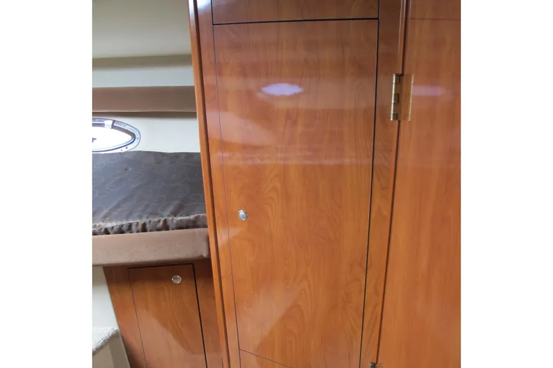 Slide: The Image of Interior of 2006 Cruisers Yachts 385 Motoryacht with wooden cabinetry and bed. - 36