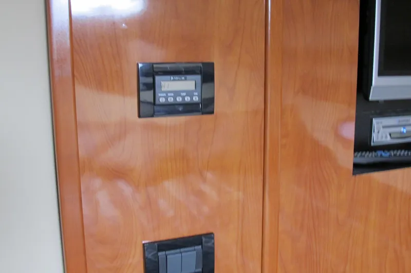 Slide: The Image of Wooden interior panel with control panel and screen on 2006 Cruisers Yachts 385 Motoryacht. - 38