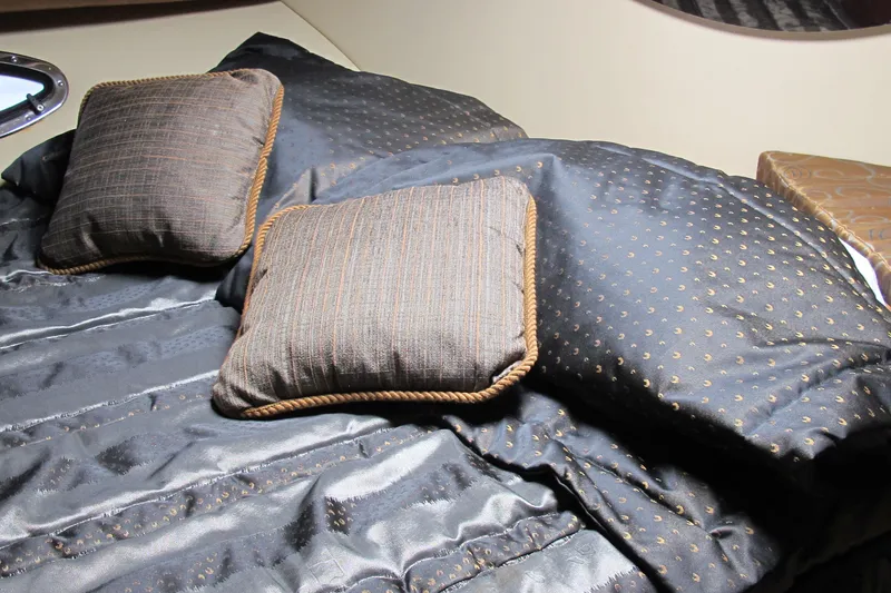 Slide: The Image of Luxurious bedding in 2006 Cruisers Yachts 385 Motoryacht cabin, featuring elegant pillows and comforter. - 39