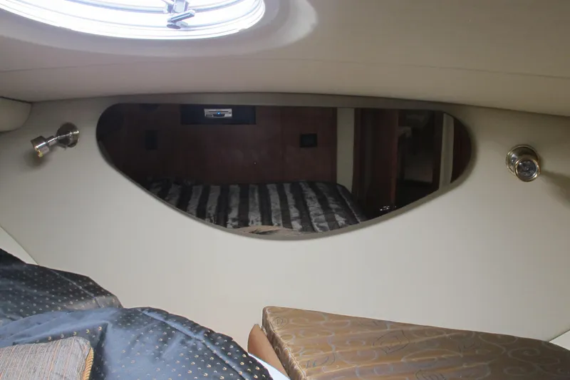 Slide: The Image of Interior cabin of 2006 Cruisers Yachts 385 Motoryacht with porthole and bedding. - 40